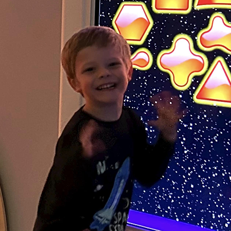 Young boy smiling in sensory room