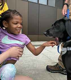 Camp Page Black Female Youth petting a dog