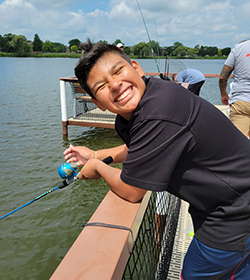 Teen age boy smiling and fishing