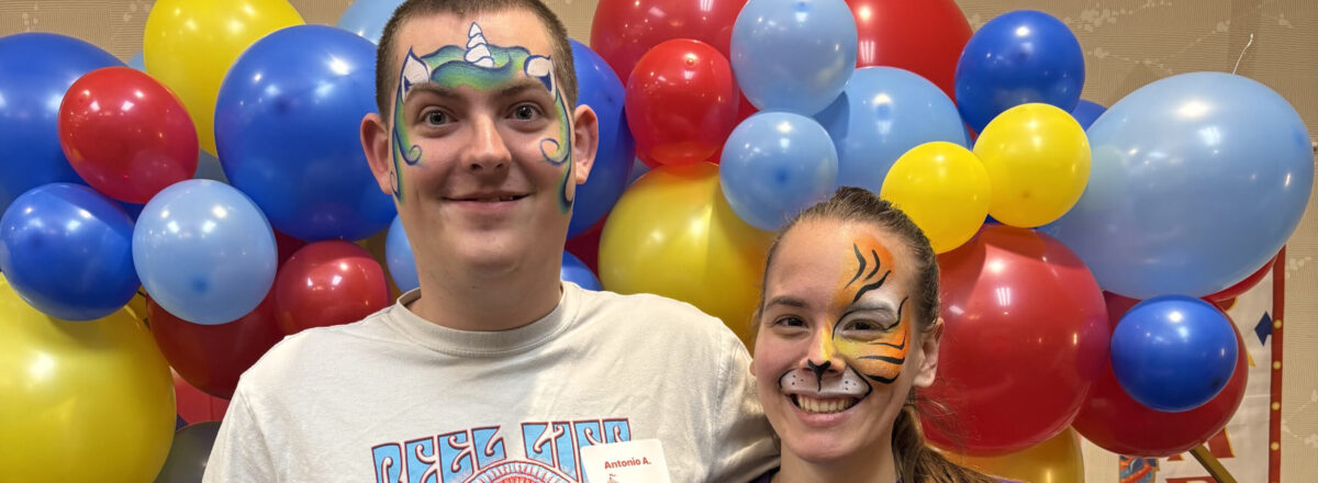 sraclc-carnival-event-face-painting Two adult participants show off their colorful face paint during a carnival event at SRACLC.