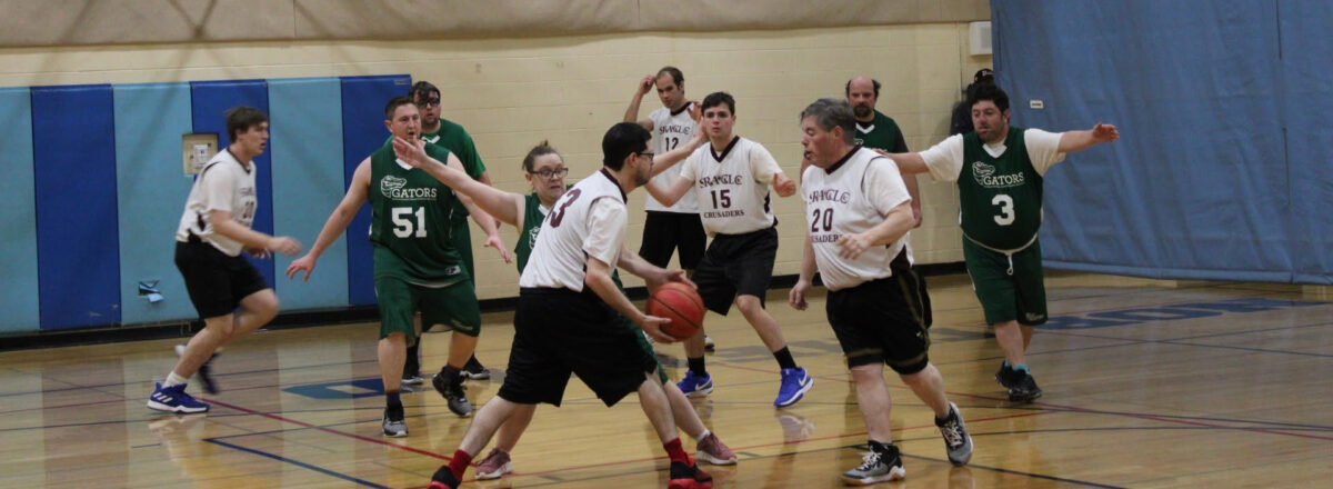sraclc-crusader-athletics-adult-basketball A group of adult athletes participates in a basketball game through SRACLC Crusader Athletics.
